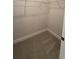 Large walk-in closet with neutral carpeting at 1590 Royal Rd, Venice, FL 34293