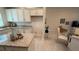 Bright kitchen and dining area with a cozy dining area and view to the living room at 1590 Royal Rd, Venice, FL 34293