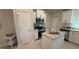 Bright kitchen featuring white cabinets, granite countertops and stainless steel appliances at 1590 Royal Rd, Venice, FL 34293