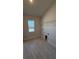 Practical laundry room featuring tile flooring, a window and storage shelves at 1590 Royal Rd, Venice, FL 34293