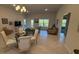 Open living room with lots of natural light, elegant furniture, and tile floors at 1590 Royal Rd, Venice, FL 34293