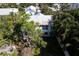 House with rusty metal roof, seen from above, surrounded by lush tropical foliage at 106 11Th S St # A, Bradenton Beach, FL 34217