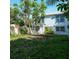 Backyard of a fixer-upper beach house, showing overgrown yard and shed at 106 11Th S St # A, Bradenton Beach, FL 34217