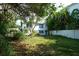 Backyard with lush landscaping and a white fence at 106 11Th S St # A, Bradenton Beach, FL 34217