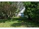 Overgrown backyard with a rustic cottage and mature trees at 106 11Th S St # A, Bradenton Beach, FL 34217