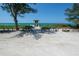 Beach access with lifeguard stand, sandy beach and clear blue water at 106 11Th S St # A, Bradenton Beach, FL 34217