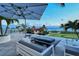 Ocean view patio with seating area and fire pit at 2251 Gulf Of Mexico Dr # 204, Longboat Key, FL 34228