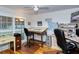 Spacious home office with hardwood floors, large windows, and plenty of storage at 7812 Broadmoor Pines Blvd, Sarasota, FL 34243