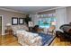 Living room with hardwood floors, floral sofas, and pool view at 7812 Broadmoor Pines Blvd, Sarasota, FL 34243