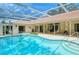 Resort-style pool and spa with covered patio at 7812 Broadmoor Pines Blvd, Sarasota, FL 34243