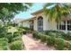 Home exterior showcasing a walkway and landscaping at 7812 Broadmoor Pines Blvd, Sarasota, FL 34243