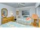 Guest bedroom with two twin beds and direct access to the pool area at 7812 Broadmoor Pines Blvd, Sarasota, FL 34243