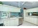 Galley kitchen with ample cabinetry, stainless steel appliances, and breakfast nook at 7812 Broadmoor Pines Blvd, Sarasota, FL 34243