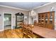 Elegant dining room showcasing a large table, hardwood floors and kitchen view at 7812 Broadmoor Pines Blvd, Sarasota, FL 34243