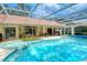 Large pool and spa with covered patio and seating area at 7812 Broadmoor Pines Blvd, Sarasota, FL 34243