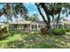 Home's backyard with lush landscaping and pool at 7812 Broadmoor Pines Blvd, Sarasota, FL 34243