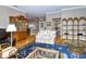 Spacious living room featuring hardwood floors, a cozy sitting area, and built-in shelving at 7812 Broadmoor Pines Blvd, Sarasota, FL 34243
