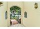 Inviting front entry with wrought iron gate and lush landscaping at 7812 Broadmoor Pines Blvd, Sarasota, FL 34243