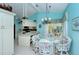 Bright kitchen with white cabinets, stainless steel appliances, and pool access at 7812 Broadmoor Pines Blvd, Sarasota, FL 34243