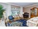 Living room with hardwood floors, floral sofas, and pool view at 7812 Broadmoor Pines Blvd, Sarasota, FL 34243