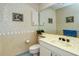 Clean bathroom with updated vanity, large mirror, and neutral color palette at 7812 Broadmoor Pines Blvd, Sarasota, FL 34243