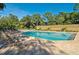 Community pool with lounge chairs and surrounding landscaping at 4575 Chandlers Forde # 46, Sarasota, FL 34235