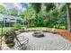 Cozy fire pit area with seating in a circular brick patio at 1130 Anclote Rd, Tarpon Springs, FL 34689