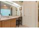 Bathroom with light wood vanity and a built-in chair at 1130 Anclote Rd, Tarpon Springs, FL 34689