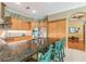 Modern kitchen with granite countertops, stainless steel appliances, and a breakfast bar at 1130 Anclote Rd, Tarpon Springs, FL 34689
