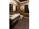 Modern bathroom with dark-toned vanity and tile floors at 640 N Owl Dr, Sarasota, FL 34236
