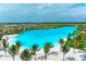 Aerial view of a large lagoon pool surrounded by palm trees at 6009 White Mangrove Ln, Bradenton, FL 34210