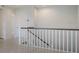 Upstairs hall with white railing and access to other rooms at 6009 White Mangrove Ln, Bradenton, FL 34210