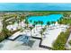 Aerial view of a crystal-clear lagoon pool with sandy beach at 6009 White Mangrove Ln, Bradenton, FL 34210