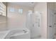 Bathroom featuring a soaking tub and glass shower at 4063 Caddie E Dr, Bradenton, FL 34203