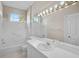Bright bathroom features white tile, vanity, and lighting at 4063 Caddie E Dr, Bradenton, FL 34203