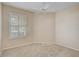 Bedroom with neutral carpet, ceiling fan, and shuttered window at 4063 Caddie E Dr, Bradenton, FL 34203