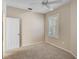 Bright bedroom with neutral carpet, ceiling fan, and white-shuttered window at 4063 Caddie E Dr, Bradenton, FL 34203