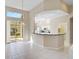 Eat-in kitchen with black granite breakfast bar and stainless steel appliances at 4063 Caddie E Dr, Bradenton, FL 34203