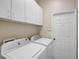Laundry room with washer, dryer, and overhead cabinets at 4063 Caddie E Dr, Bradenton, FL 34203