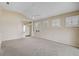 Bright living room features large windows with plantation shutters and neutral color palette at 4063 Caddie E Dr, Bradenton, FL 34203