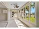 Bright sunroom featuring multiple windows offering picturesque views of the surrounding landscape at 4063 Caddie E Dr, Bradenton, FL 34203