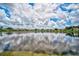 Stunning lakefront view of community with lush landscaping and beautiful homes at 4063 Caddie E Dr, Bradenton, FL 34203