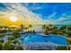 Resort-style pool with a scenic waterfront view at sunset at 376 Aruba Cir # 301, Bradenton, FL 34209