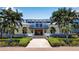 Community clubhouse with palm trees and landscaping at 376 Aruba Cir # 301, Bradenton, FL 34209