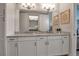 Double vanity bathroom with granite countertops and a large mirror at 376 Aruba Cir # 301, Bradenton, FL 34209
