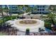 Circular fountain with seating and landscaping in a courtyard setting at 376 Aruba Cir # 301, Bradenton, FL 34209