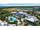 Community pool and clubhouse with surrounding landscape at 376 Aruba Cir # 301, Bradenton, FL 34209