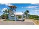 Community entrance with guardhouse and tropical landscaping at 376 Aruba Cir # 301, Bradenton, FL 34209