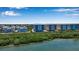 Aerial view of waterfront property showcasing multiple buildings and lush vegetation at 376 Aruba Cir # 301, Bradenton, FL 34209