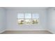 Bedroom with large windows overlooking a pond and landscaping at 3426 79Th Street W Cir # 202, Bradenton, FL 34209